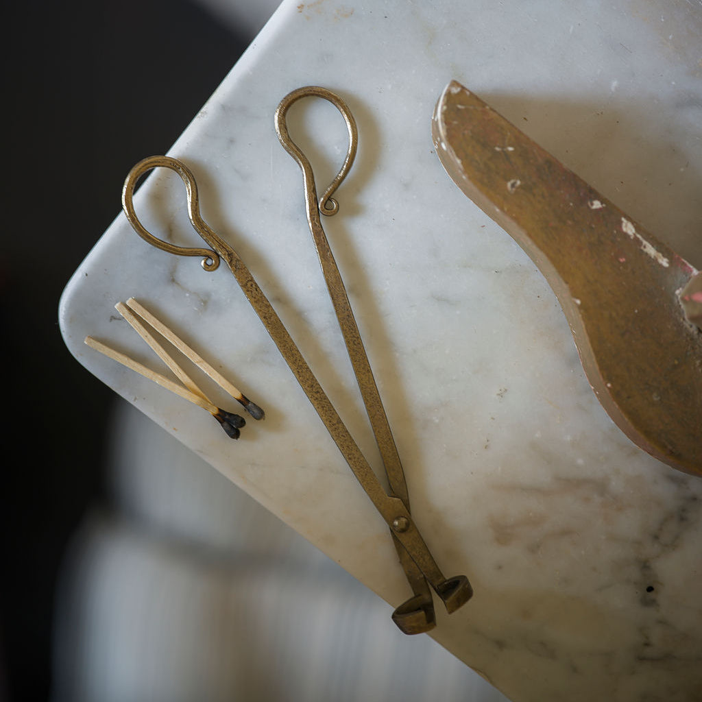 Set of vintage-style brass tools on a marble surface